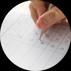 a close-up of a hand ticking an item on a checklist