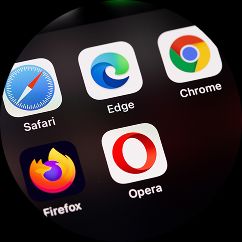 A close-up image of a phone with different web browser apps logos appearing.