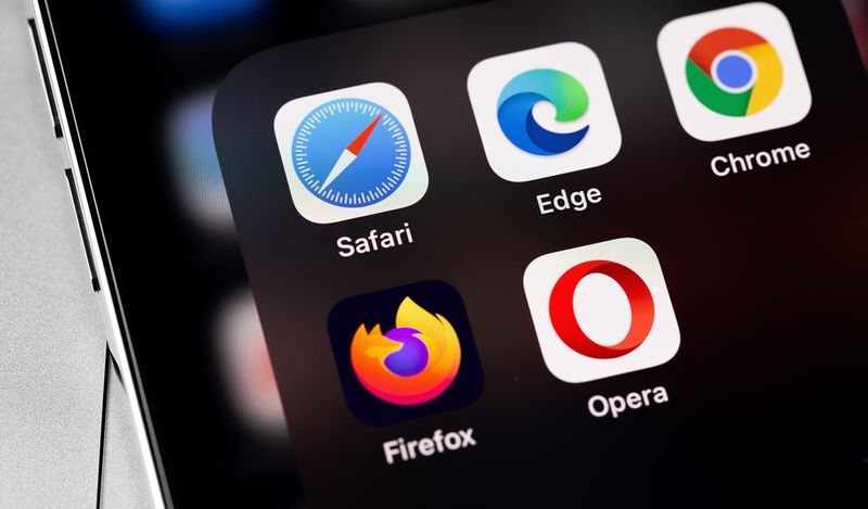 What is Cross-Browser Testing A close-up image of a phone with different web browser apps logos appearing.