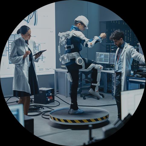 Image of scientists in a lab, with someone testing robotic legs.