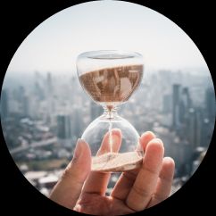 image of a hand holding an hour glass