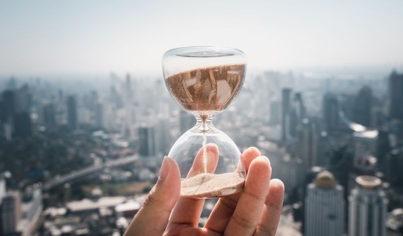 image of a hand holding an hour glass