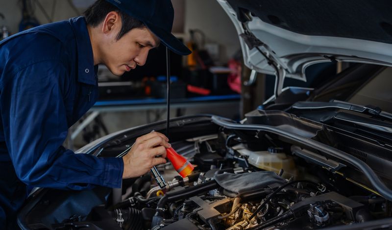 image of a mechanic making checks to a car as a metaphor for manual regression checks