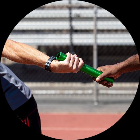 Two hands passing a baton in a relay race, representing the continuous handoff between stages in the agile software development lifecycle