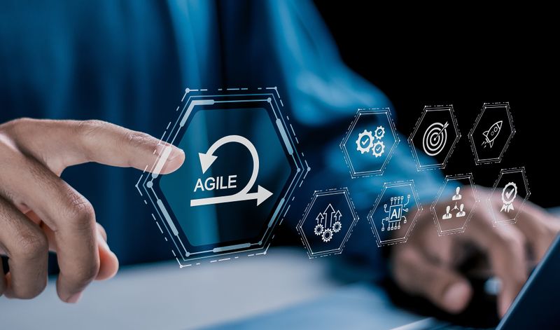 Person at a laptop with agile process icons overlay, illustrating agile testing tools and workflows