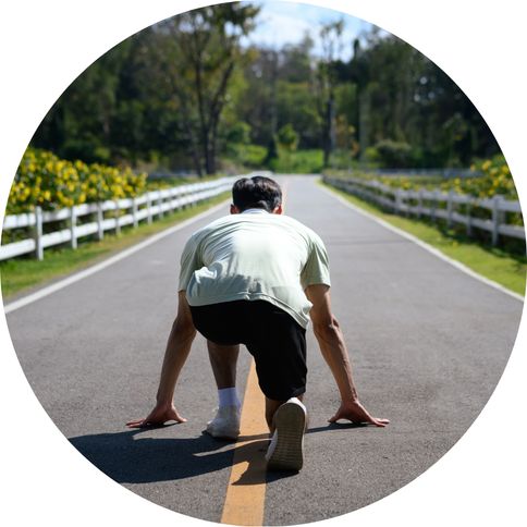 Man viewed from behind in a running stance on a street, poised to start, representing getting started with agile testing