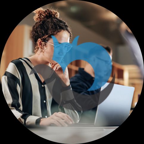 women at a computer with a PractiTest logo over the top.